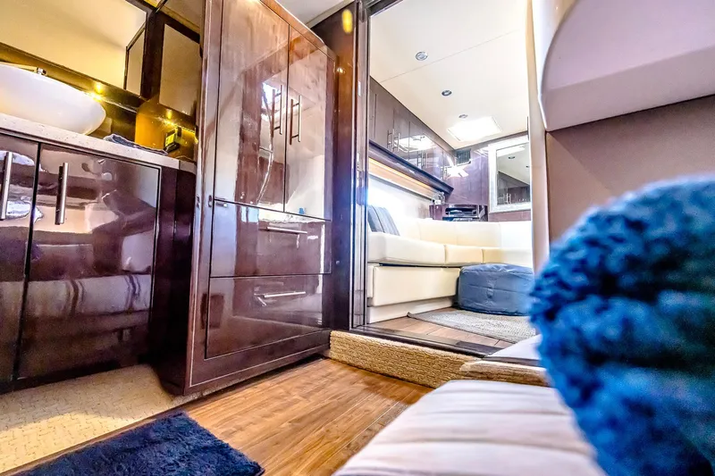  Yacht Photos Pics Luxurious interior of a 2016 Regal 46 Sport Coupe yacht, featuring elegant wood finishes.