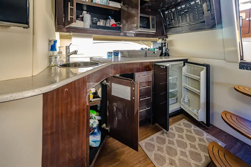  Yacht Photos Pics 2016 Regal 46 Sport Coupe yacht kitchen with open cabinets and modern amenities.