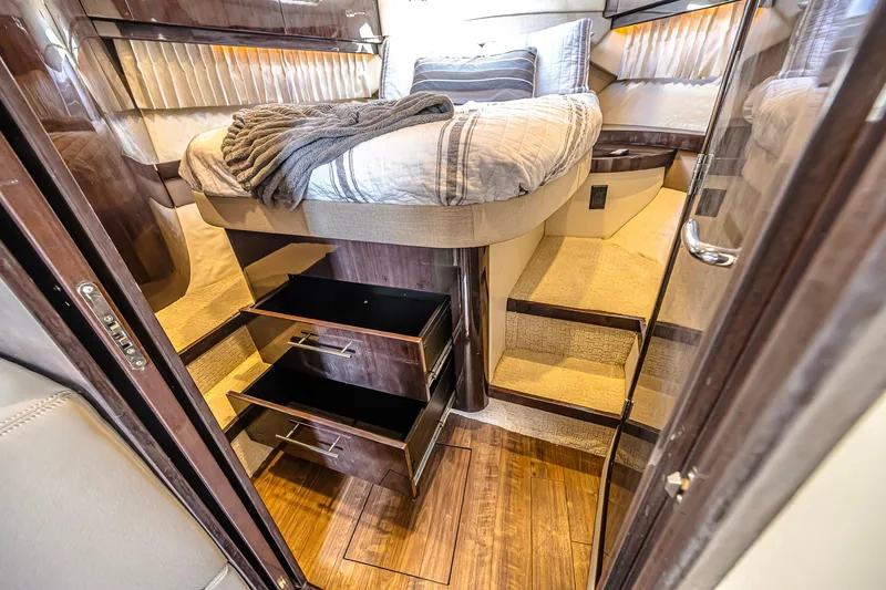  Yacht Photos Pics Luxurious cabin interior of 2016 Regal 46 Sport Coupe with bed and storage drawers.