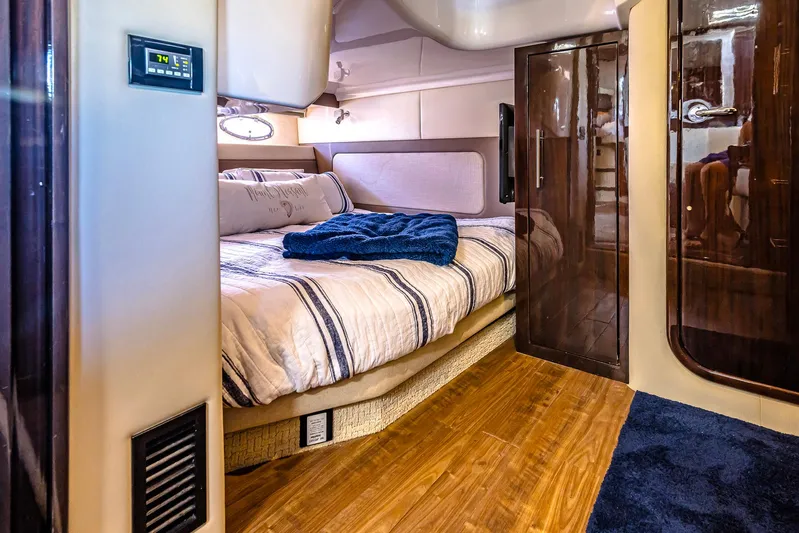  Yacht Photos Pics Luxurious interior of 2016 Regal 46 Sport Coupe with cozy bed and elegant wood finishes.