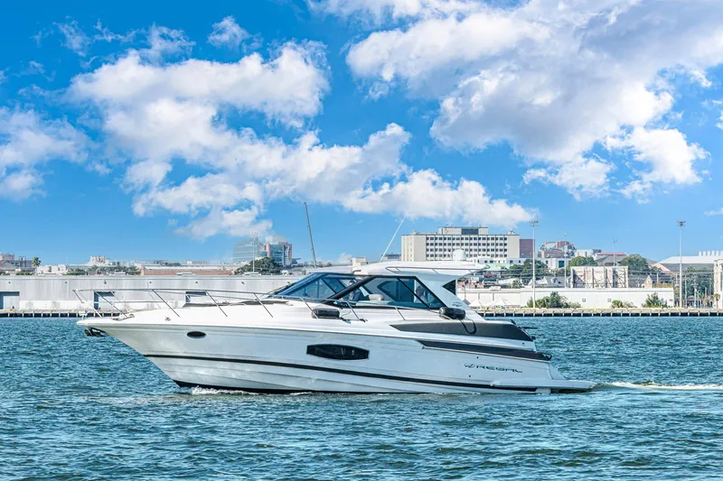  Yacht Photos Pics 2016 Regal 46 Sport Coupe cruising on water under a bright blue sky.