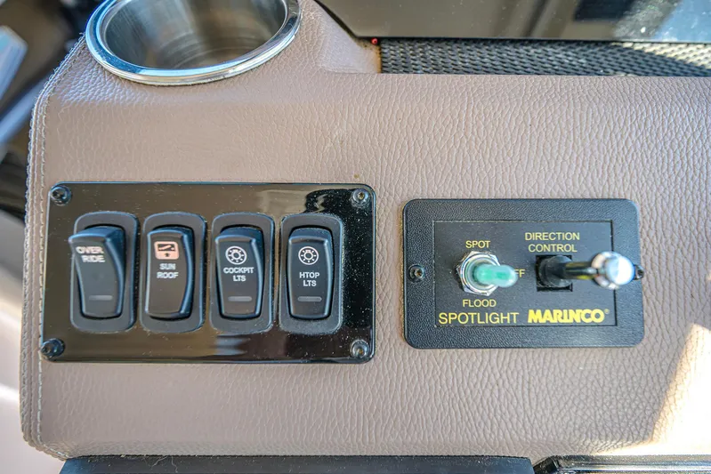  Yacht Photos Pics Control panel of a 2016 Regal 46 Sport Coupe with switches and spotlight controls.