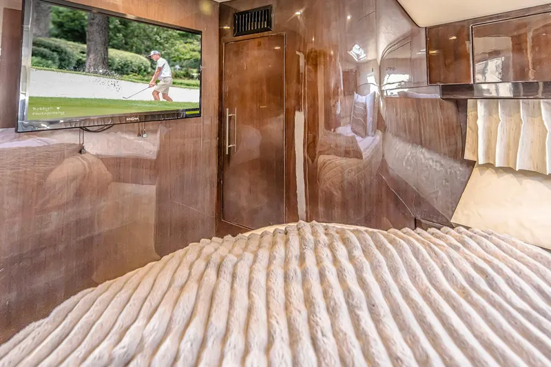  Yacht Photos Pics Luxurious interior of 2016 Regal 46 Sport Coupe with TV and plush bedding.