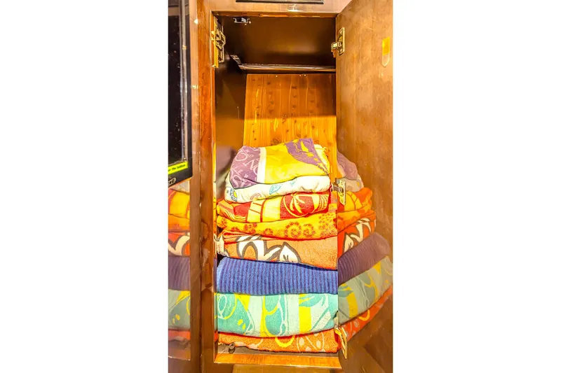  Yacht Photos Pics Stacked colorful towels in a wooden cabinet aboard a 2016 Regal 46 Sport Coupe.