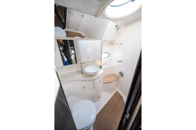  Yacht Photos Pics 2016 Regal 46 Sport Coupe bathroom with modern fixtures and wooden flooring.