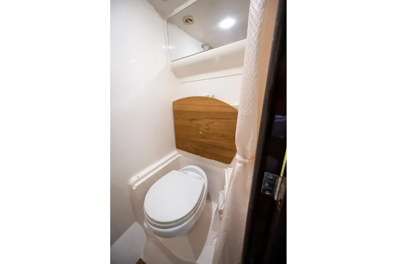  Yacht Photos Pics 2016 Regal 46 Sport Coupe bathroom with modern fixtures and wooden accents.