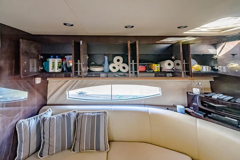  Yacht Photos Pics Interior of 2016 Regal 46 Sport Coupe with open cabinets and striped cushions.