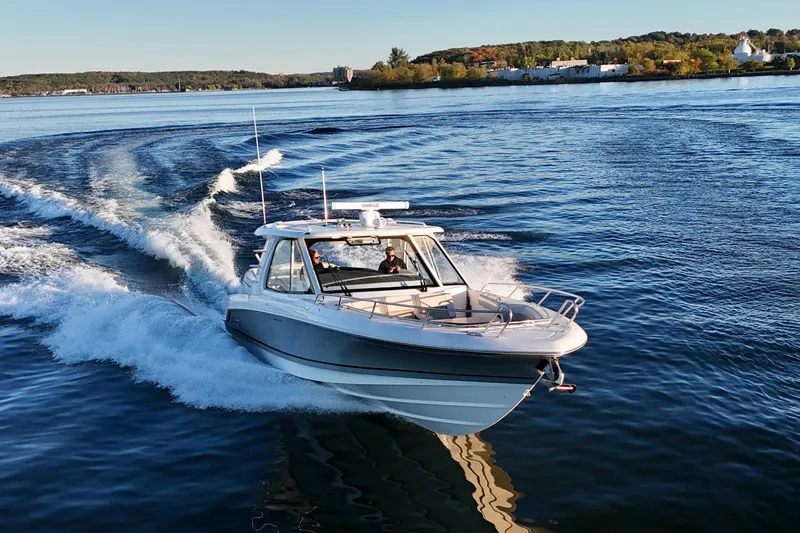  Yacht Photos Pics 2024 Boston Whaler 380 Realm cruising on a scenic lake.