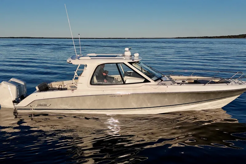  Yacht Photos Pics 2024 Boston Whaler 380 Realm cruising on calm waters under clear skies.