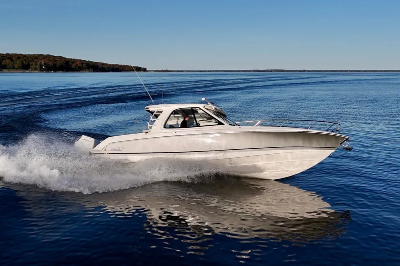  Yacht Photos Pics 2024 Boston Whaler 380 Realm cruising on open water, showcasing sleek design and performance.