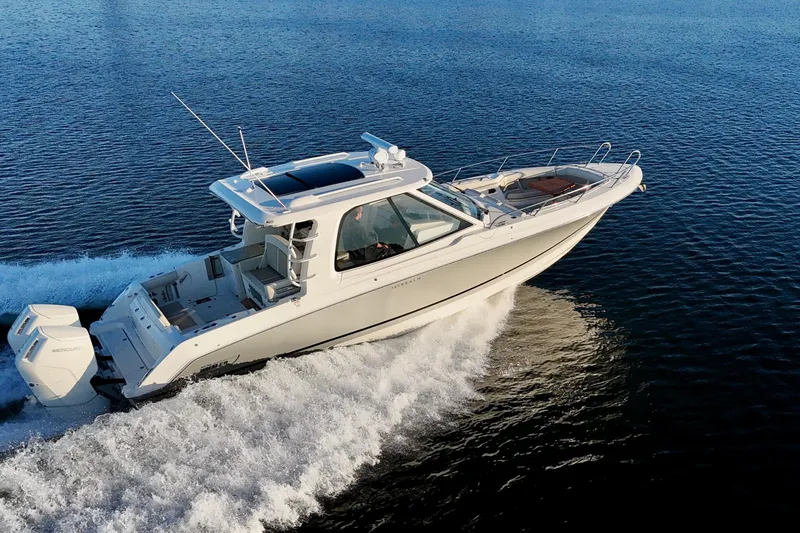  Yacht Photos Pics 2024 Boston Whaler 380 Realm cruising on open water, showcasing sleek design and powerful engines.