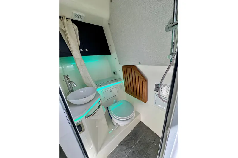  Yacht Photos Pics 2024 Boston Whaler 380 Realm bathroom with modern fixtures and ambient lighting.