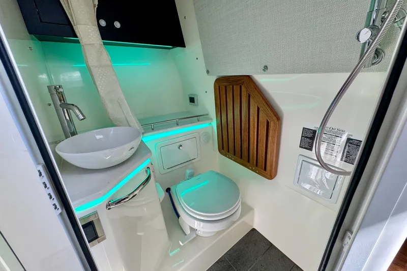  Yacht Photos Pics Luxurious bathroom in 2024 Boston Whaler 380 Realm boat with modern fixtures and ambient lighting.