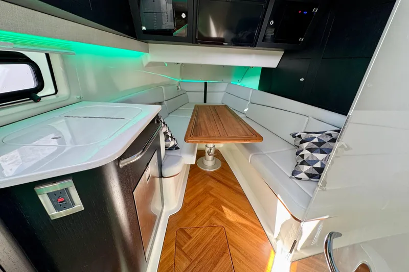  Yacht Photos Pics Luxurious interior of 2024 Boston Whaler 380 Realm with modern seating and wooden table.