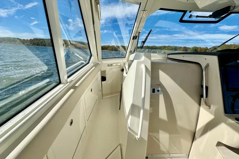  Yacht Photos Pics 2024 Boston Whaler 380 Realm interior with scenic water view through windows.