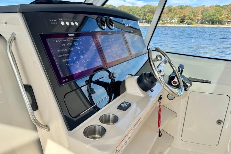  Yacht Photos Pics 2024 Boston Whaler 380 Realm helm with advanced navigation displays and steering wheel.