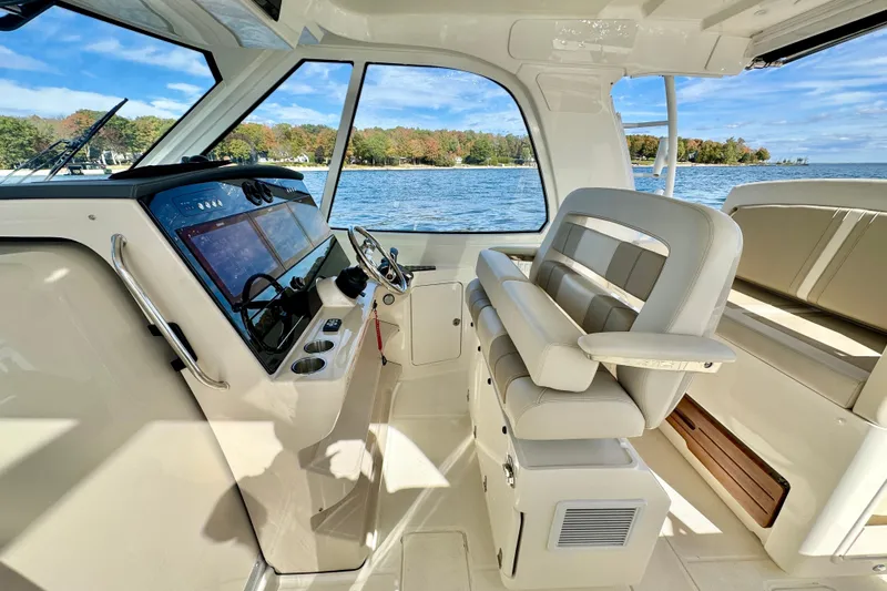  Yacht Photos Pics 2024 Boston Whaler 380 Realm interior with helm, seating, and scenic water view.