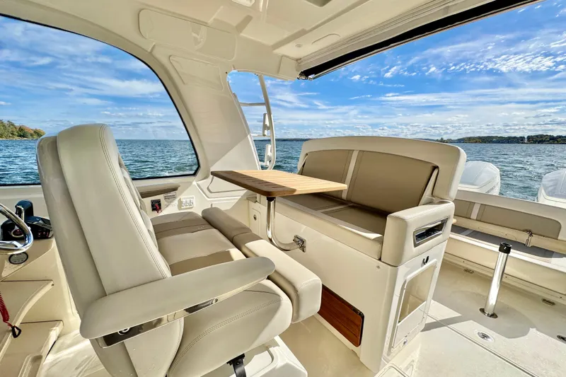  Yacht Photos Pics Luxurious interior of 2024 Boston Whaler 380 Realm boat with seating and table, overlooking water.