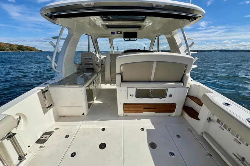  Yacht Photos Pics 2024 Boston Whaler 380 Realm boat interior, featuring spacious deck and seating, on open water.
