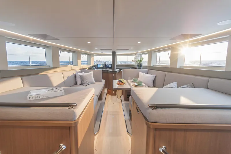 Savoir Faire Yacht Photos Pics Luxurious interior of 2025 MCP Global Exp 68 yacht with elegant seating and ocean view.