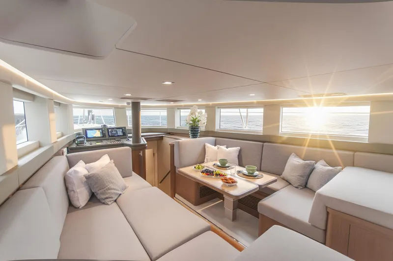 Savoir Faire Yacht Photos Pics Luxurious interior of 2025 MCP Global Exp 68 yacht with elegant seating and ocean view.