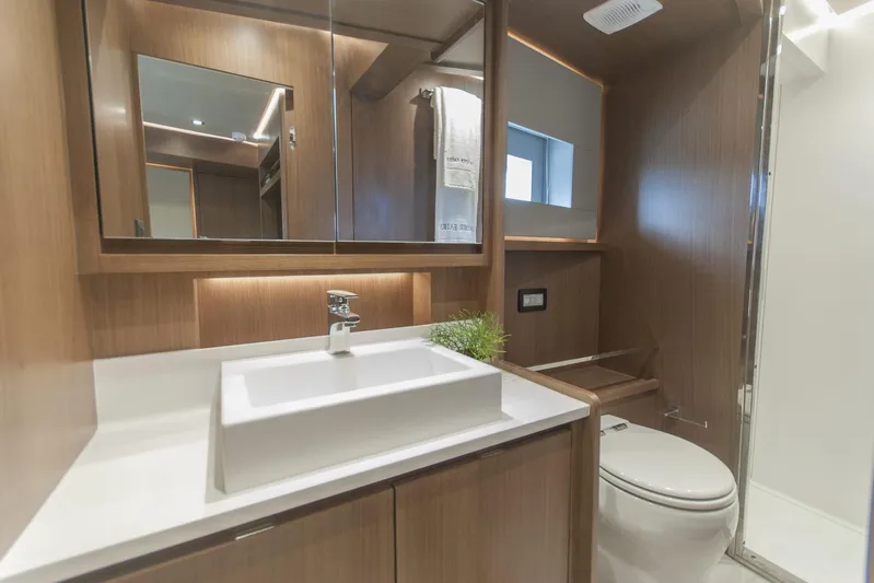 Savoir Faire Yacht Photos Pics Modern bathroom interior in 2025 MCP Global Exp 68 yacht, featuring sleek wood finishes and contemporary fixtures.