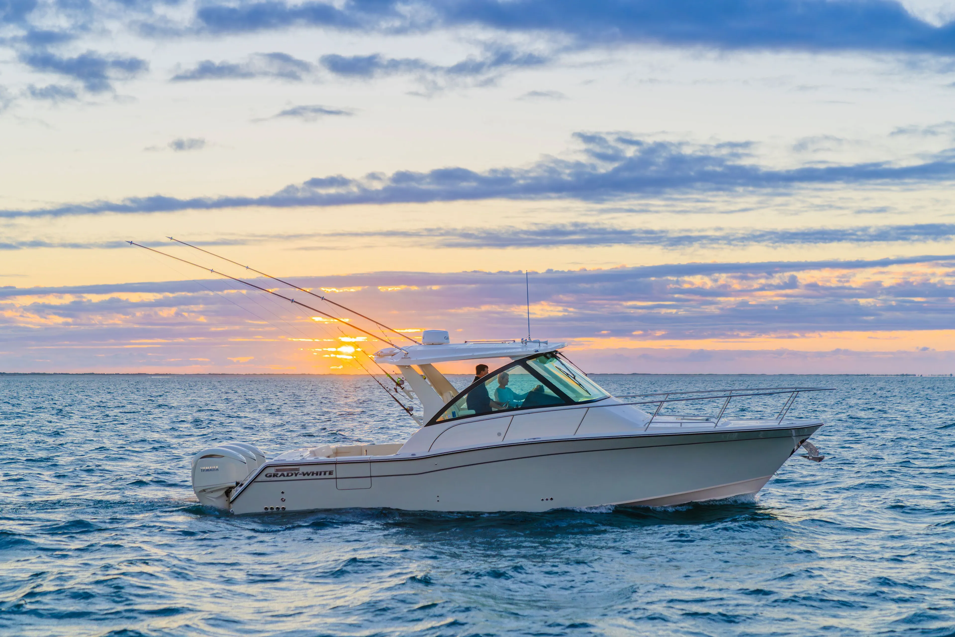 Grady-White 340EXP 2026 boat at sunset on the ocean.