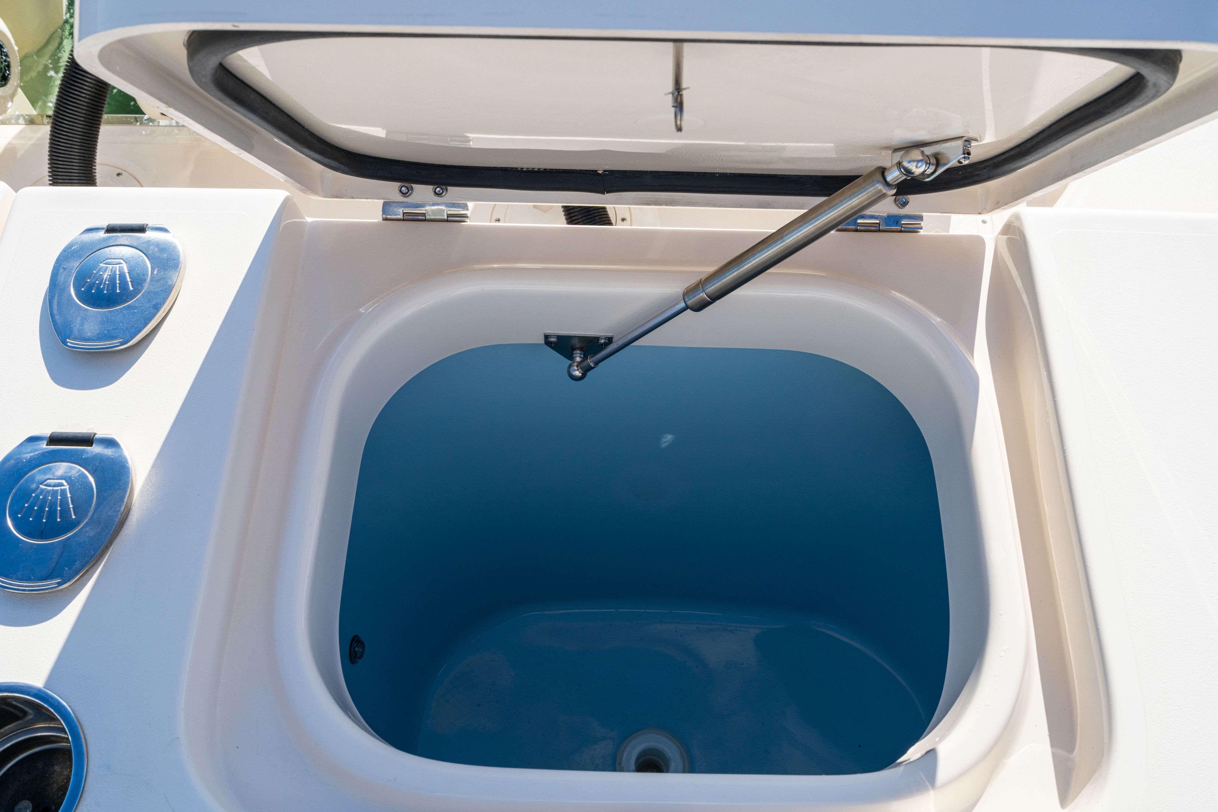 Grady-White 340EXP 2026 boat, open storage compartment with hydraulic strut.