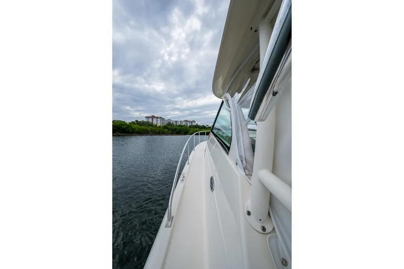 Bottoms Up II Yacht Photos Pics 2009 Pursuit OS 375 Offshore boat cruising on a calm river under cloudy skies.