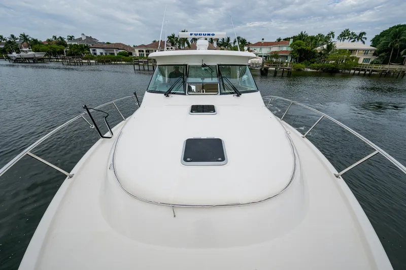Bottoms Up II Yacht Photos Pics 2009 Pursuit OS 375 Offshore boat on calm water near residential area.