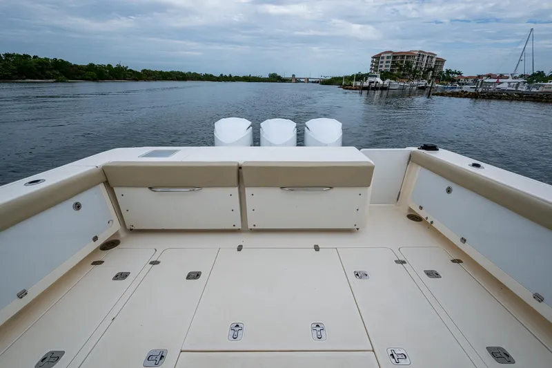 Bottoms Up II Yacht Photos Pics 2009 Pursuit OS 375 Offshore boat deck with scenic waterfront view.