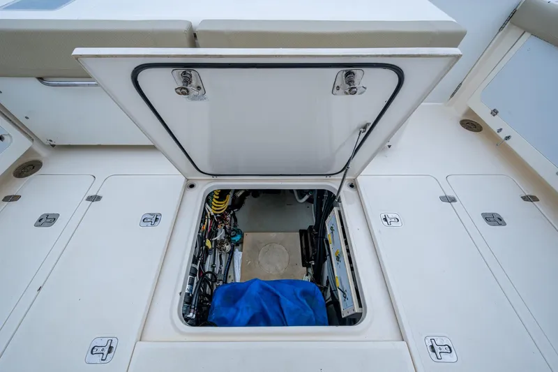 Bottoms Up II Yacht Photos Pics Open hatch on 2009 Pursuit OS 375 Offshore boat deck, revealing engine compartment.