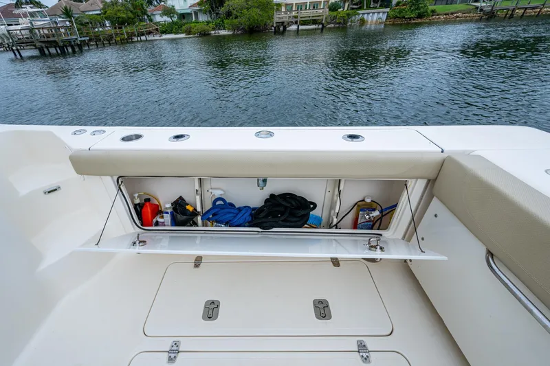 Bottoms Up II Yacht Photos Pics 2009 Pursuit OS 375 Offshore boat storage compartment with equipment, dockside view.
