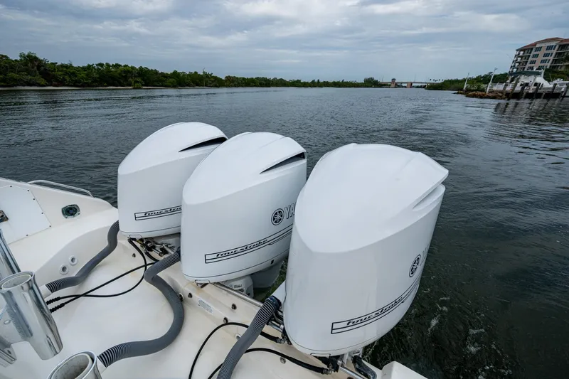 Bottoms Up II Yacht Photos Pics 2009 Pursuit OS 375 Offshore boat with triple Yamaha outboard engines on a calm waterway.
