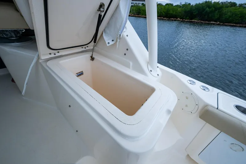 Bottoms Up II Yacht Photos Pics Open storage compartment on 2009 Pursuit OS 375 Offshore boat, near water.