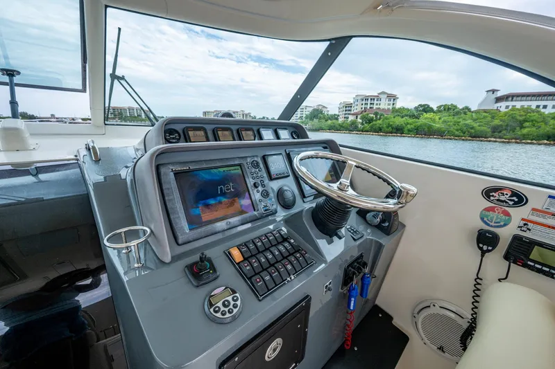 Bottoms Up II Yacht Photos Pics 2009 Pursuit OS 375 Offshore helm with advanced navigation system and steering wheel.