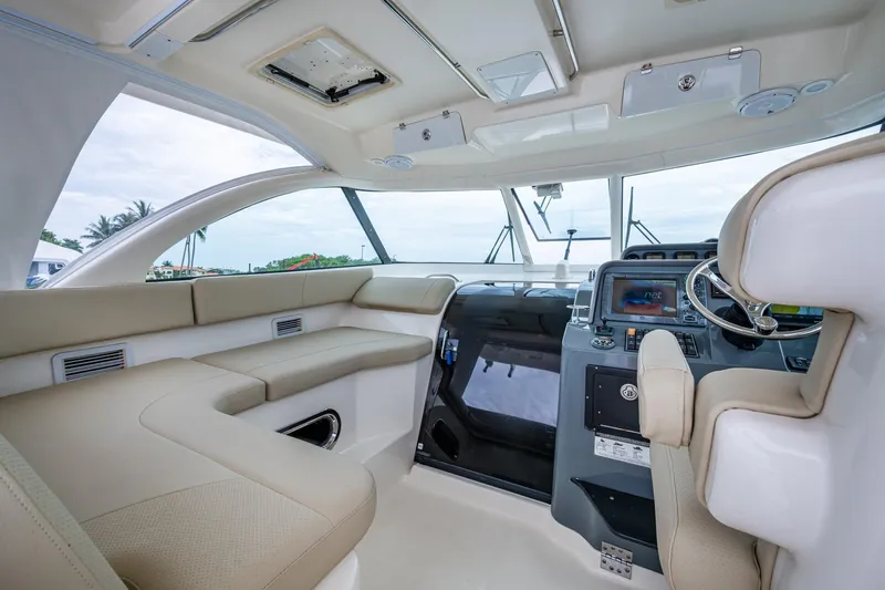 Bottoms Up II Yacht Photos Pics Luxurious interior of a 2009 Pursuit OS 375 Offshore boat with modern helm and seating.