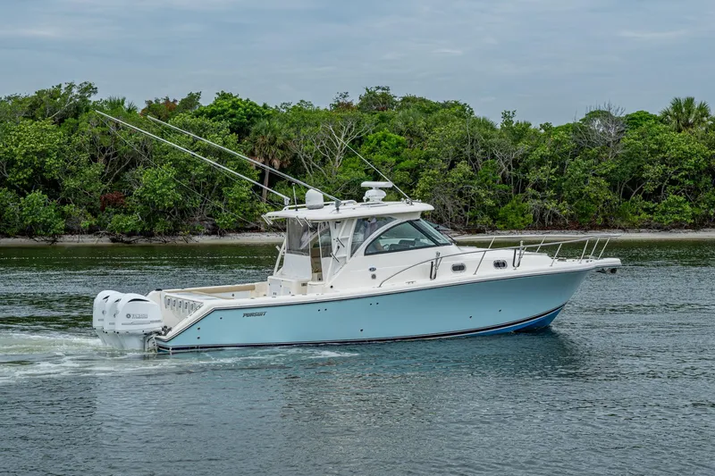 Bottoms Up II Yacht Photos Pics 2009 Pursuit OS 375 Offshore boat cruising near lush green shoreline.