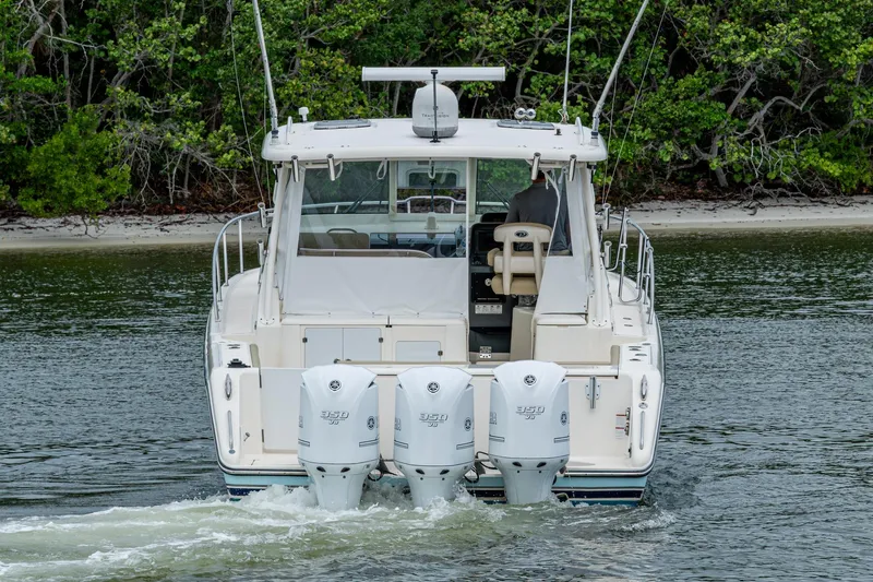 Bottoms Up II Yacht Photos Pics 2009 Pursuit OS 375 Offshore boat with triple outboard engines on calm water.
