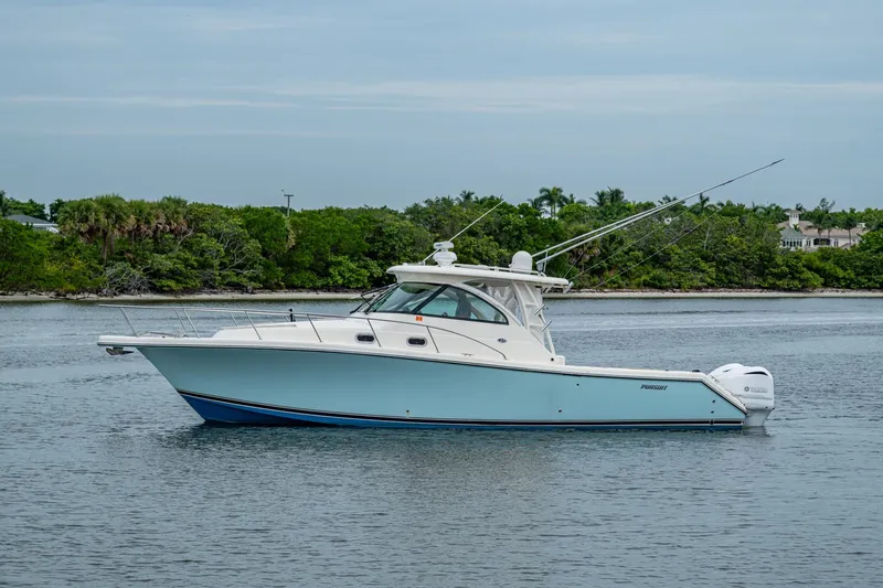 Bottoms Up II Yacht Photos Pics 2009 Pursuit OS 375 Offshore boat on calm water, surrounded by lush greenery.