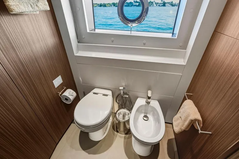Randy Beth Yacht Photos Pics Luxurious yacht bathroom with toilet, bidet, and ocean view porthole, Custom Line 120, 2018.
