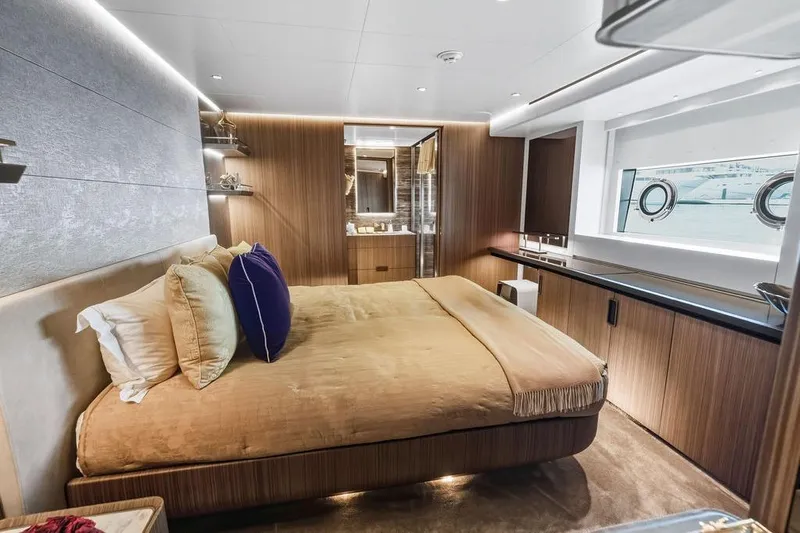 Randy Beth Yacht Photos Pics Luxurious yacht bedroom interior, Custom Line 120, 2018 model, featuring elegant wood paneling.