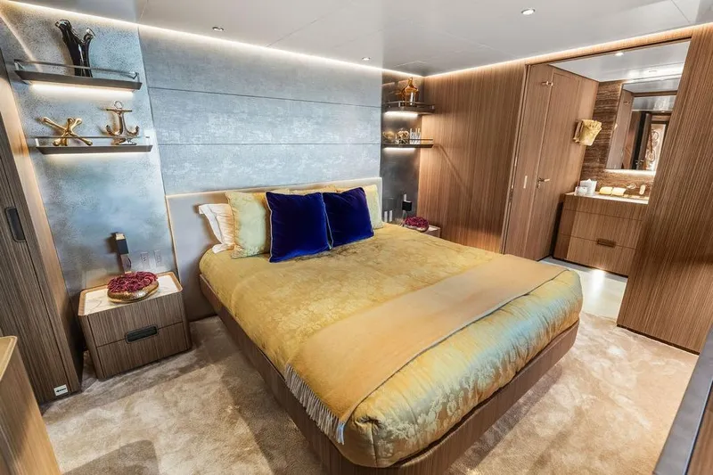 Randy Beth Yacht Photos Pics Luxurious bedroom interior on a 2018 Custom Line 120 yacht, featuring elegant decor and modern amenities.