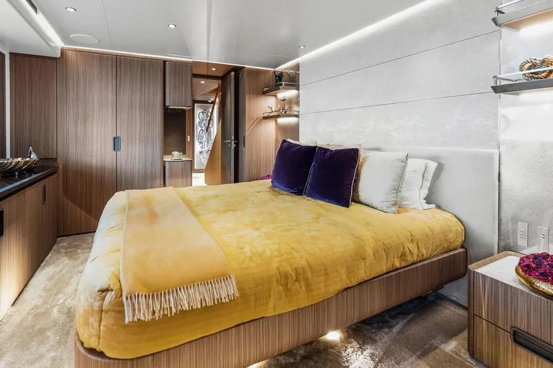 Randy Beth Yacht Photos Pics Luxurious bedroom interior on a 2018 Custom Line 120 yacht, featuring modern design and plush bedding.