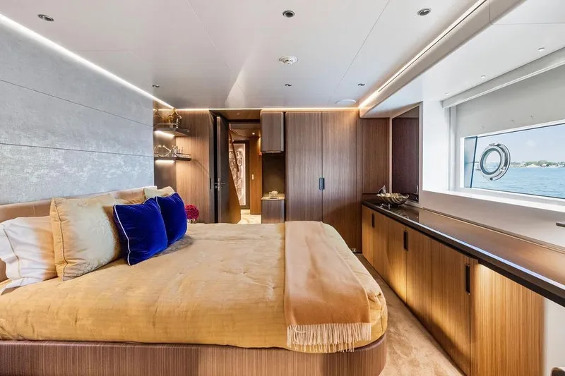 Randy Beth Yacht Photos Pics Luxurious yacht bedroom with elegant decor, featuring a large bed and scenic ocean view. Custom Line 120, 2018.