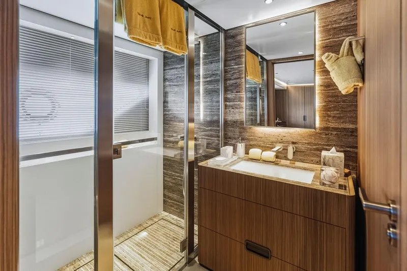 Randy Beth Yacht Photos Pics Luxurious yacht bathroom with modern wood finishes, glass shower, and elegant lighting, Custom Line 120, 2018.