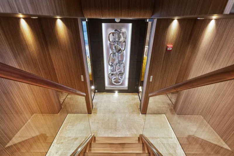 Randy Beth Yacht Photos Pics Luxurious yacht interior with wooden staircase and modern art, Custom Line 120, 2018.