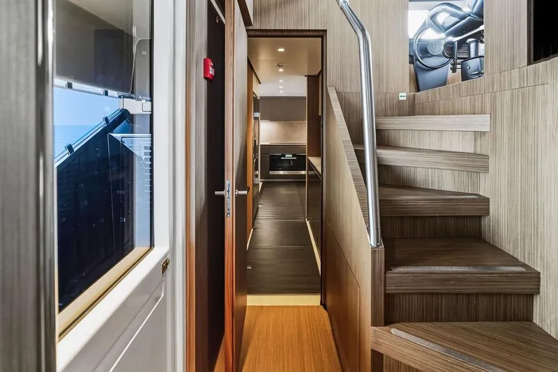 Randy Beth Yacht Photos Pics Interior of 2018 Custom Line 120 yacht, featuring modern wood staircase and sleek hallway design.