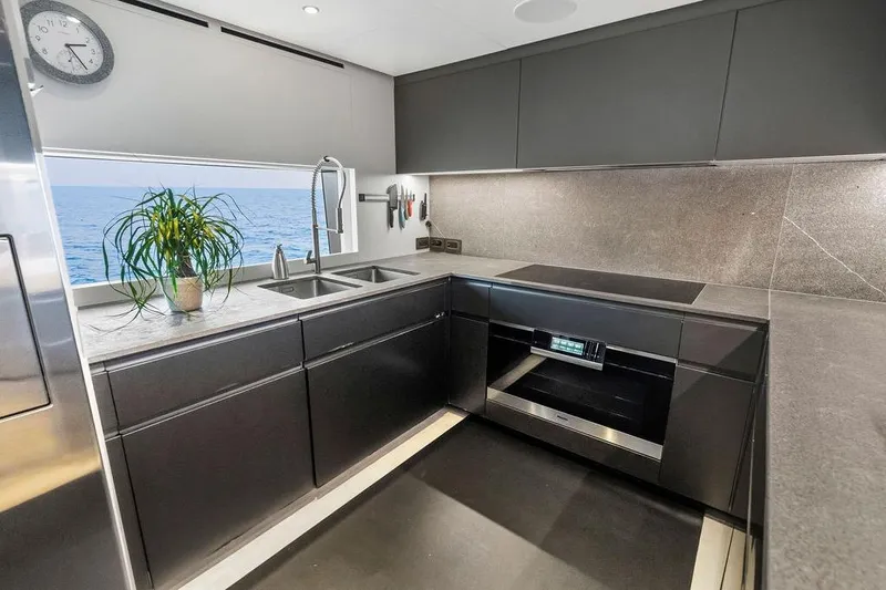 Randy Beth Yacht Photos Pics Modern yacht kitchen with sleek design, ocean view, and stainless steel appliances. Custom Line 120, 2018.