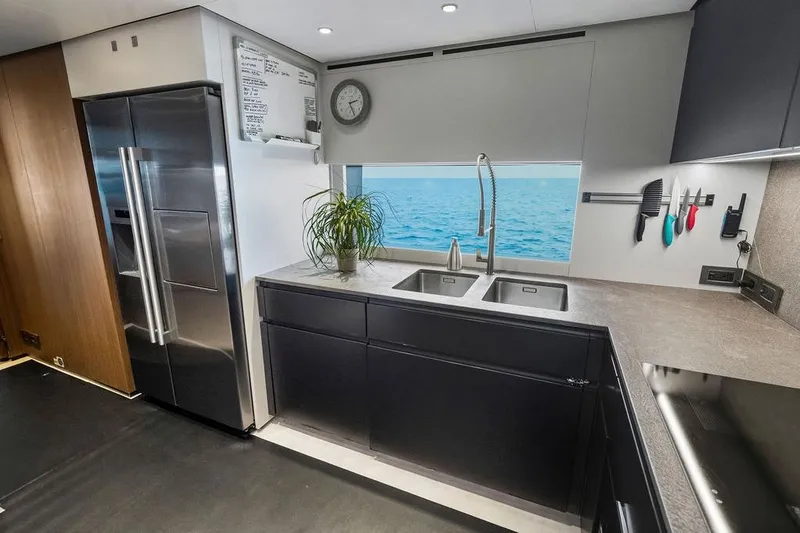 Randy Beth Yacht Photos Pics Modern yacht kitchen with ocean view, stainless steel appliances, and sleek cabinetry. Custom Line 120, 2018.
